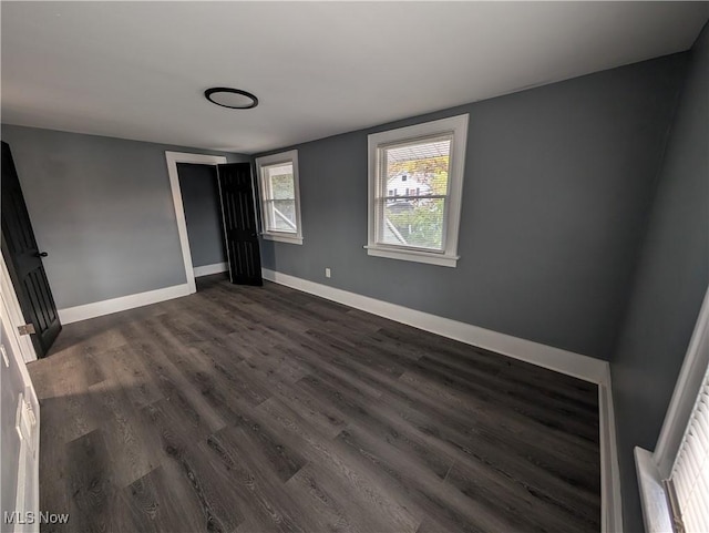 unfurnished bedroom featuring dark hardwood / wood-style floors