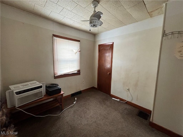 interior space with carpet, ceiling fan, and a wall mounted air conditioner