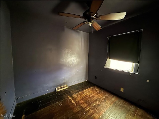 spare room with ceiling fan and dark hardwood / wood-style flooring