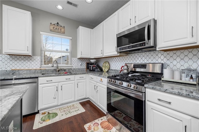 kitchen featuring light stone countertops, sink, white cabinets, and appliances with stainless steel finishes