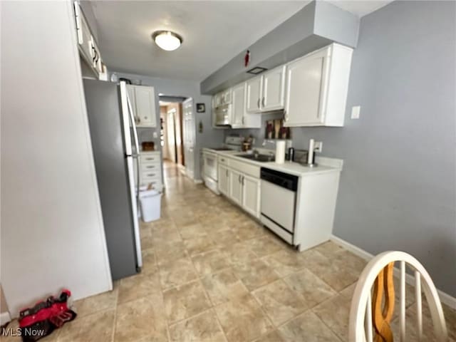 kitchen featuring sink, white appliances, and white cabinets