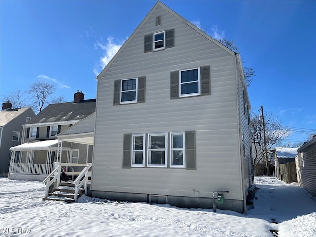 snow covered house with a porch