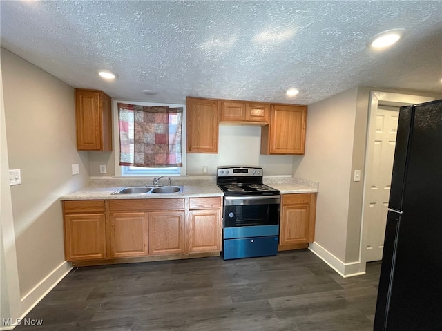 kitchen with stainless steel range with electric stovetop, black fridge, sink, a textured ceiling, and dark hardwood / wood-style flooring