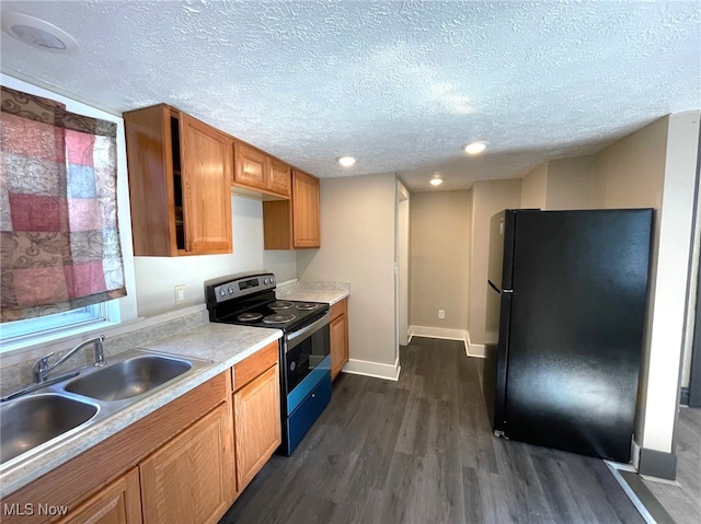 kitchen featuring dark wood-type flooring, black refrigerator, electric stove, sink, and a textured ceiling