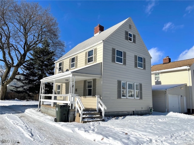 view of front of property featuring covered porch and a garage