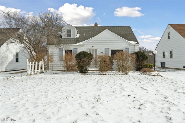 view of snow covered rear of property