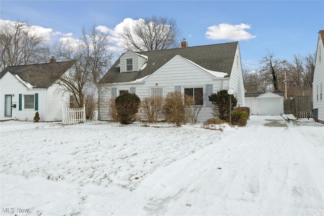 view of front of home with a garage and an outdoor structure