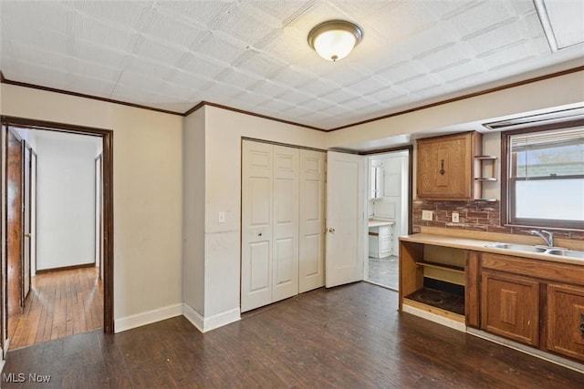 kitchen featuring decorative backsplash, dark hardwood / wood-style flooring, and sink