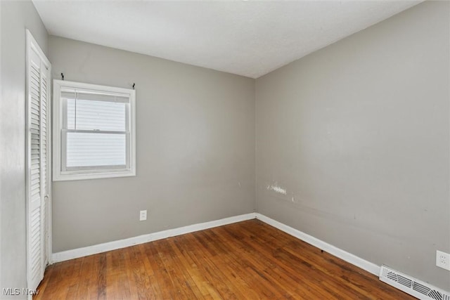 empty room featuring wood-type flooring