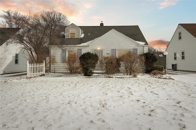 view of snow covered back of property