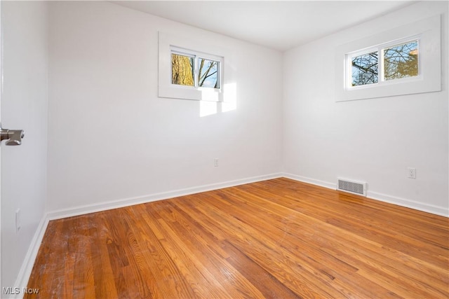 unfurnished room with wood-type flooring