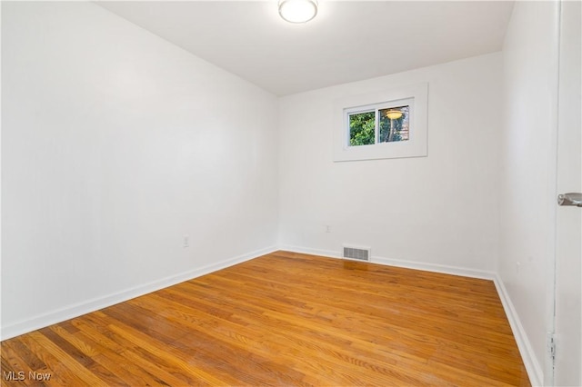 spare room featuring hardwood / wood-style floors