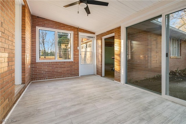 unfurnished sunroom featuring ceiling fan and vaulted ceiling