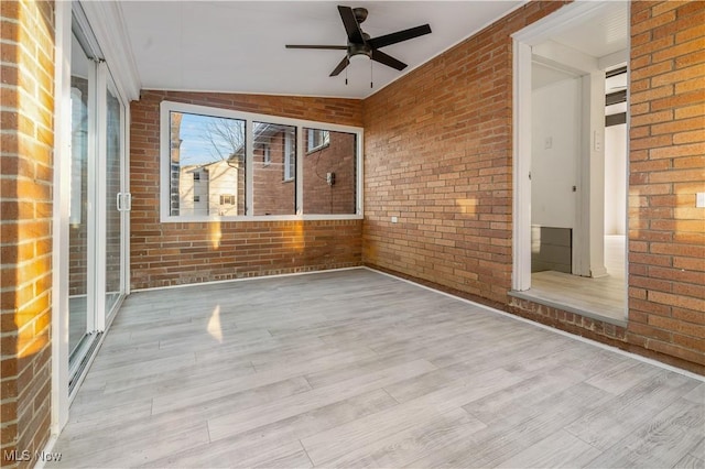 unfurnished sunroom featuring ceiling fan and lofted ceiling