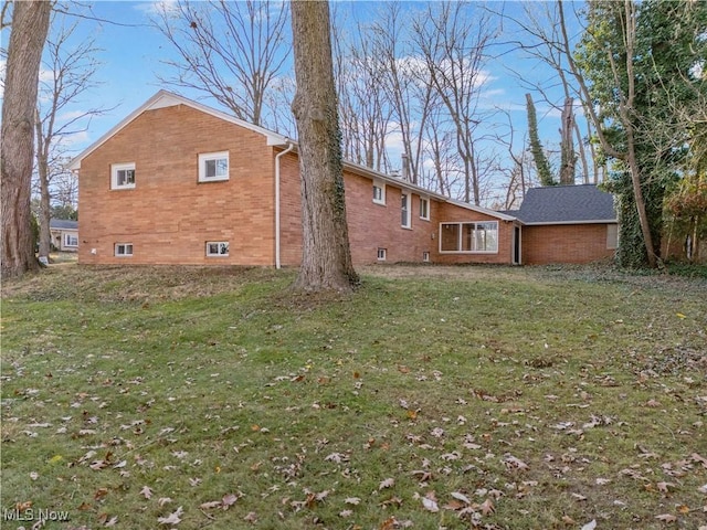 rear view of house with a yard