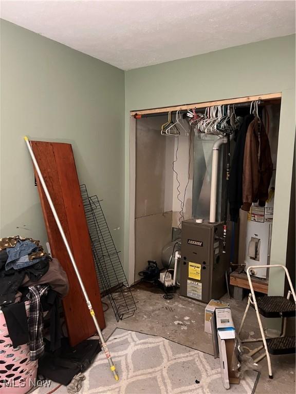 bedroom with concrete flooring and a closet