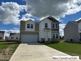 view of front of home featuring a garage and a front lawn