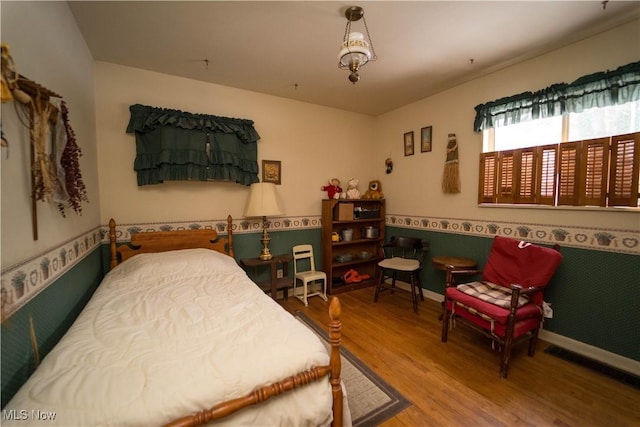 bedroom with hardwood / wood-style floors