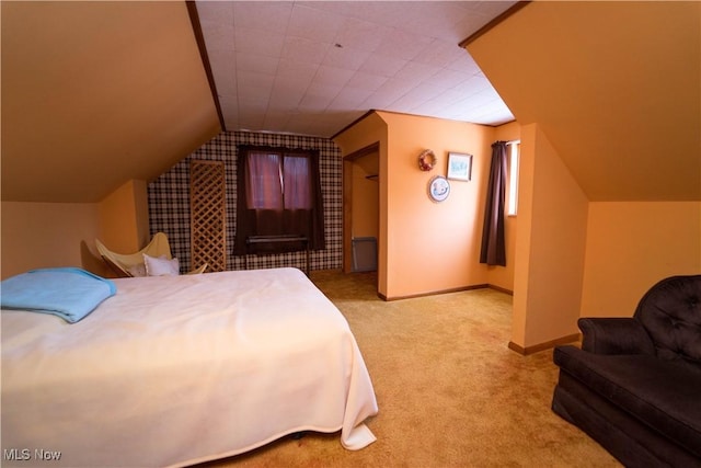 carpeted bedroom featuring lofted ceiling