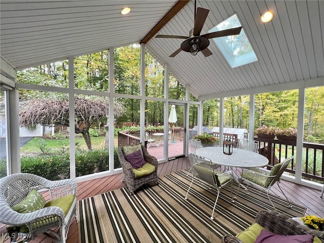 sunroom featuring ceiling fan and vaulted ceiling