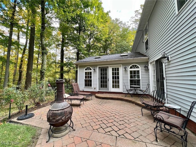 view of patio / terrace with french doors and an outdoor fire pit