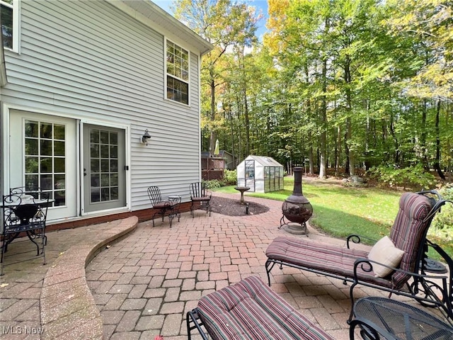 view of patio with an outbuilding