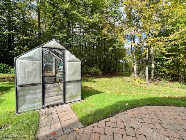 view of outdoor structure featuring a lawn