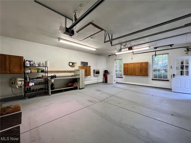 garage featuring heating unit and a garage door opener