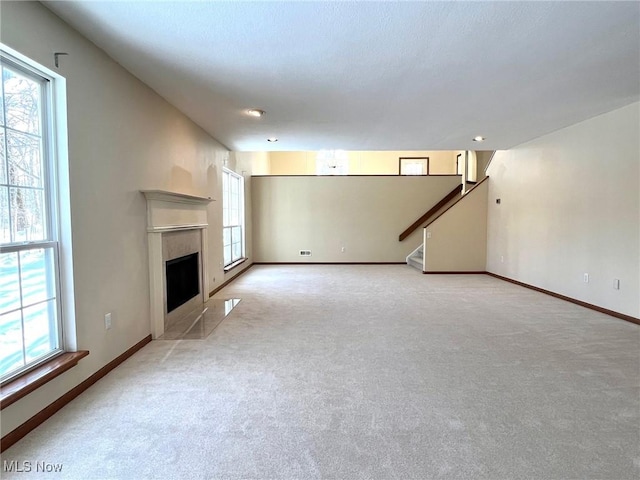 unfurnished living room featuring light carpet