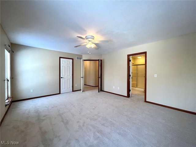 unfurnished bedroom with ceiling fan and light colored carpet