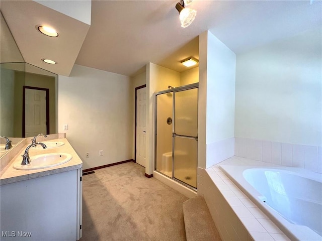 bathroom featuring vanity and shower with separate bathtub