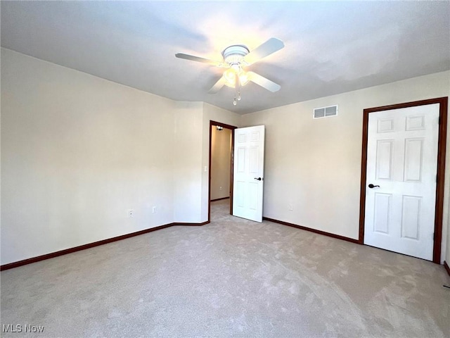 unfurnished bedroom with light colored carpet and ceiling fan