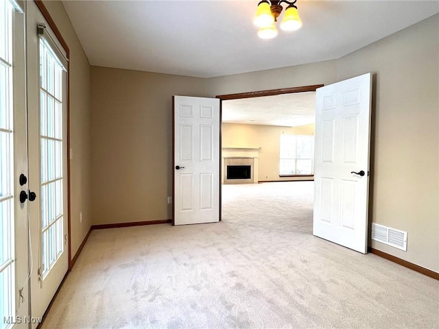 empty room with light carpet and french doors