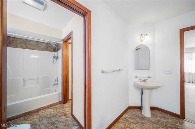 11579 Olde Stone Ct, Concord, OH 44077 - bathroom featuring baseboards, a sink, and shower / washtub combination