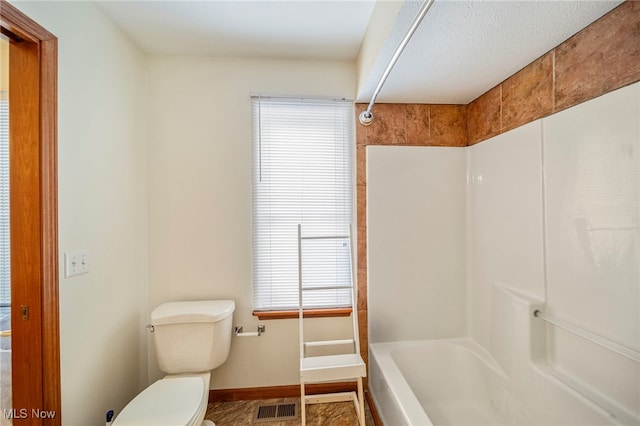 bathroom with shower / tub combination and toilet