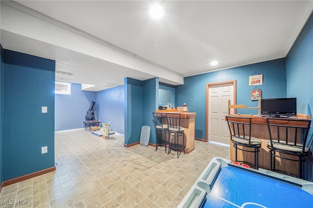 game room with bar and crown molding