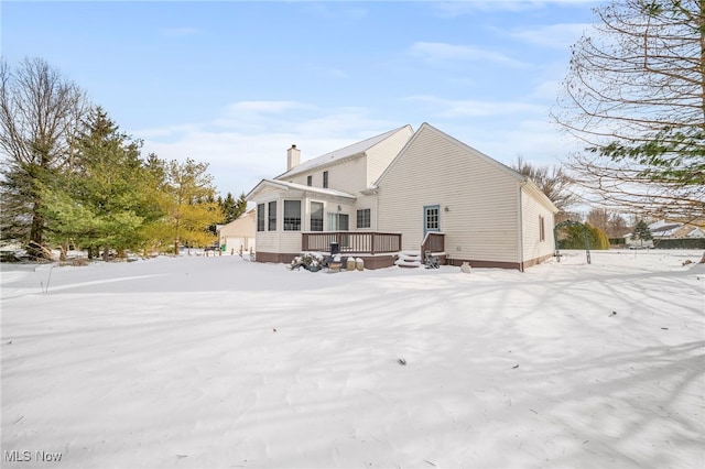 snow covered property with a wooden deck