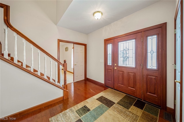 entrance foyer with dark hardwood / wood-style floors