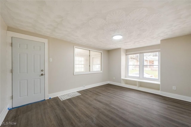 entrance foyer featuring a textured ceiling and dark wood-type flooring