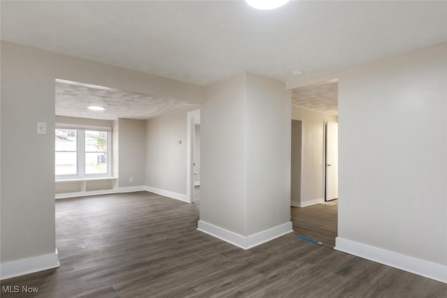 empty room with dark hardwood / wood-style flooring