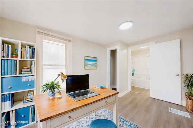 office space with light wood-type flooring