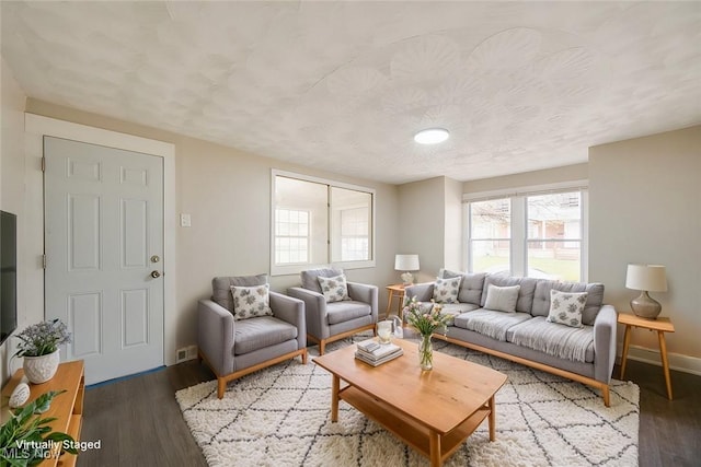 living room with hardwood / wood-style flooring and a textured ceiling