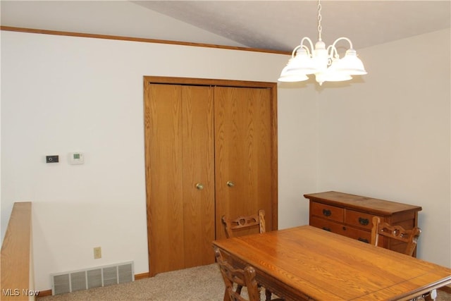 carpeted dining space with vaulted ceiling and a notable chandelier