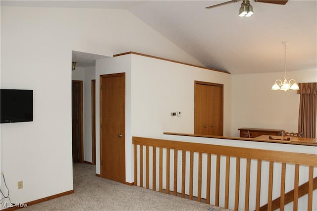 interior space with ceiling fan with notable chandelier and vaulted ceiling