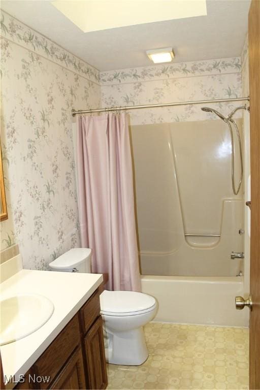 full bathroom featuring shower / bath combination with curtain, toilet, and vanity