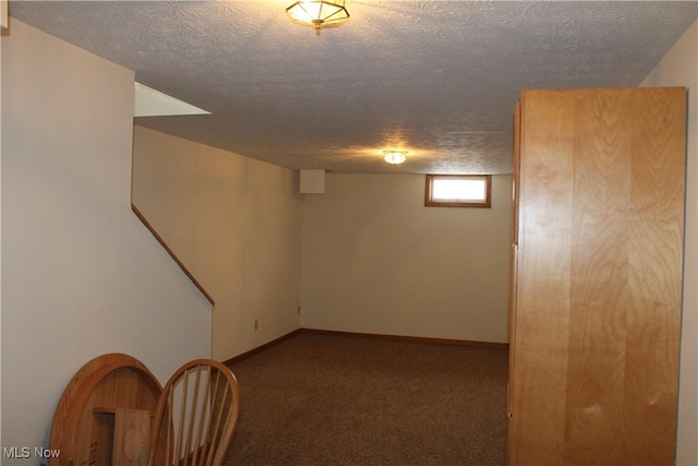 basement with carpet floors and a textured ceiling