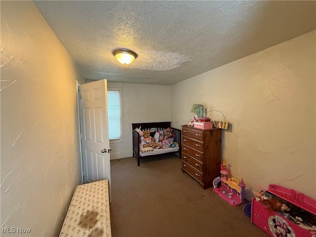 bedroom with carpet and a textured ceiling