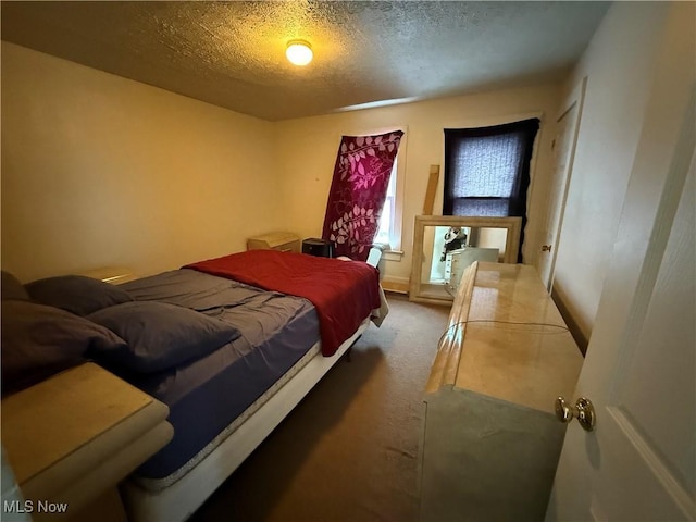 carpeted bedroom with a textured ceiling