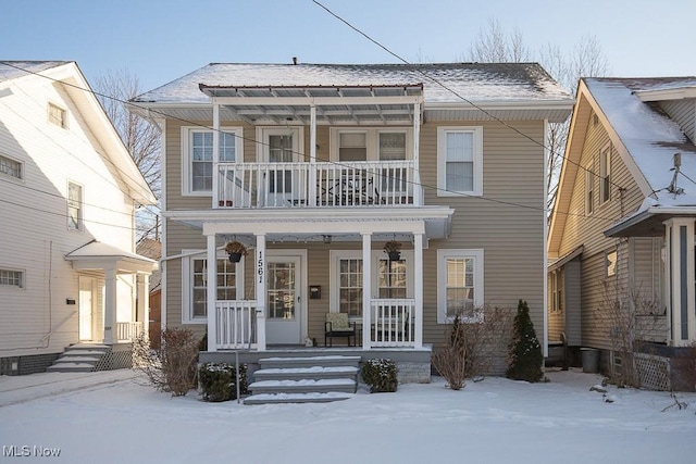 view of front of home featuring covered porch and a balcony