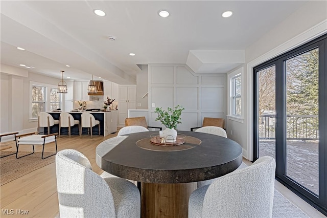 dining space featuring light hardwood / wood-style flooring and a healthy amount of sunlight